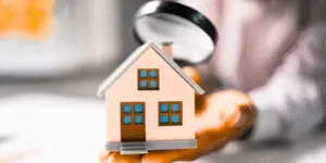 home under magnifying glass